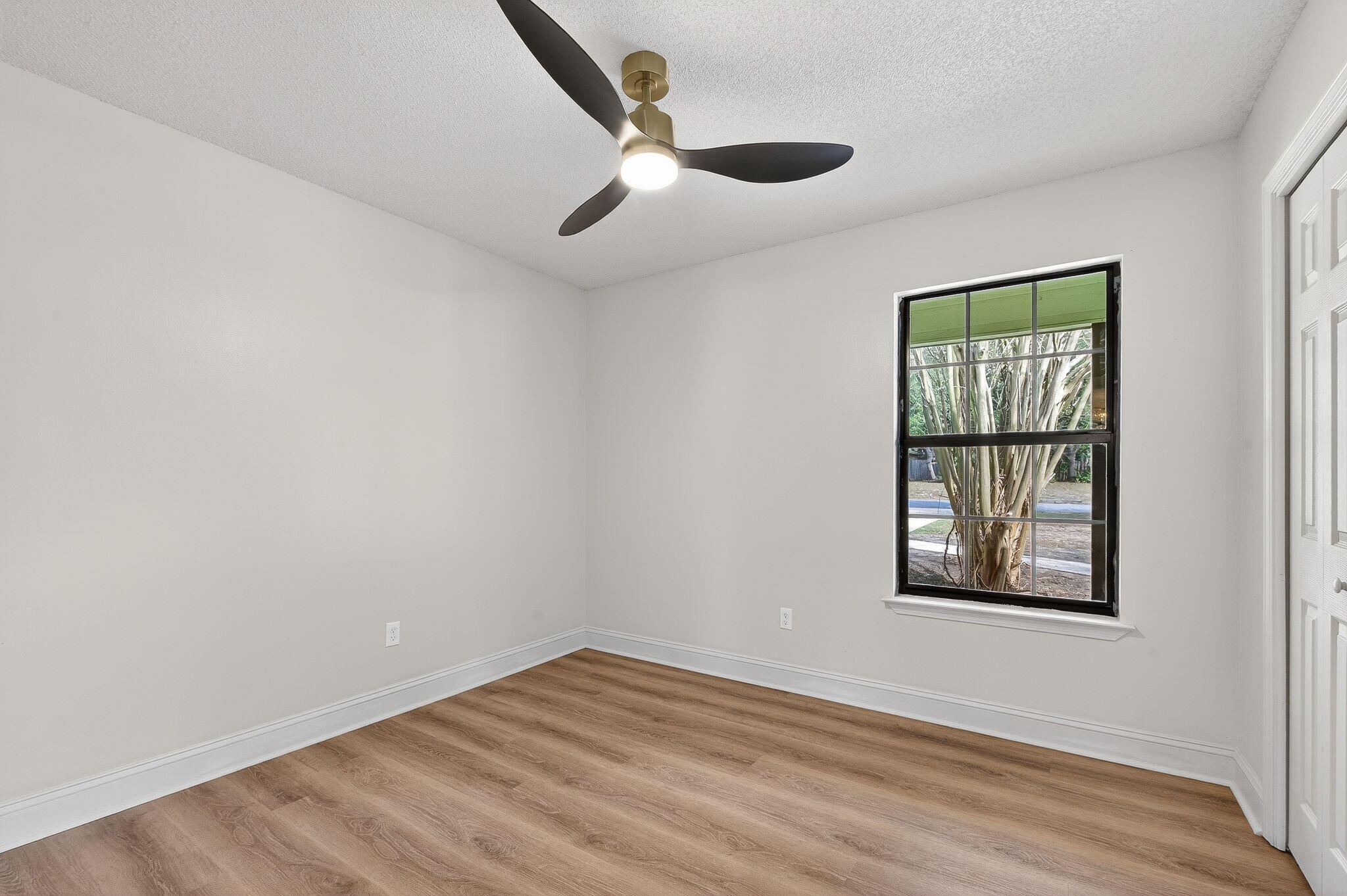 932 Ridgewood Way Niceville, FL 32578 - Photo 38 of 47 an empty room with wooden floor chandelier and windows