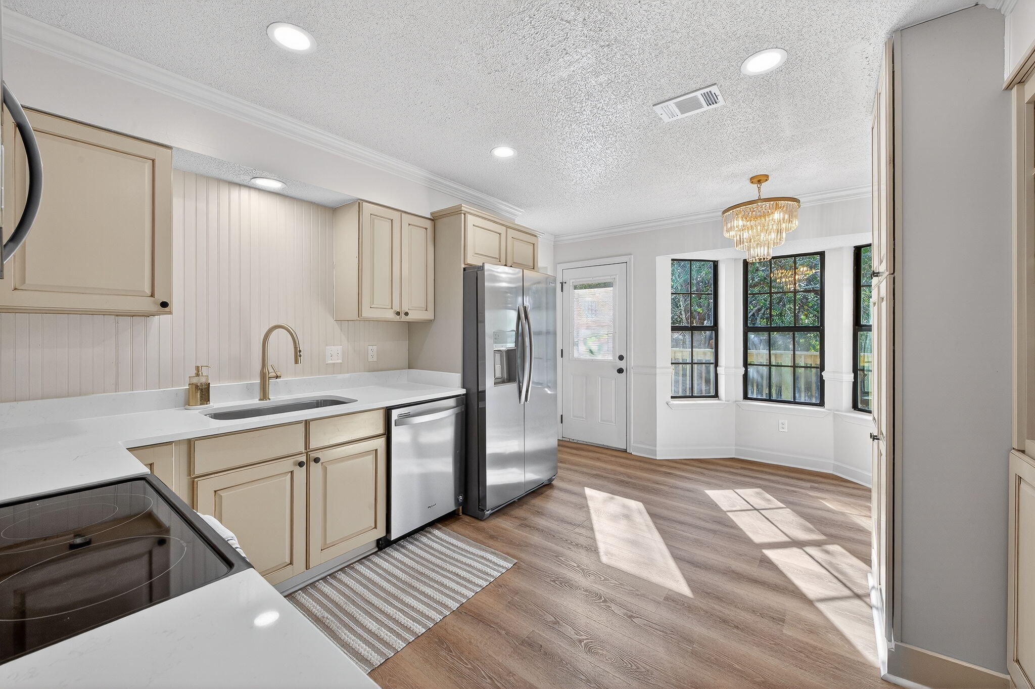 932 Ridgewood Way Niceville, FL 32578 - Photo 6 of 47 a kitchen with a sink windows and white cabinets