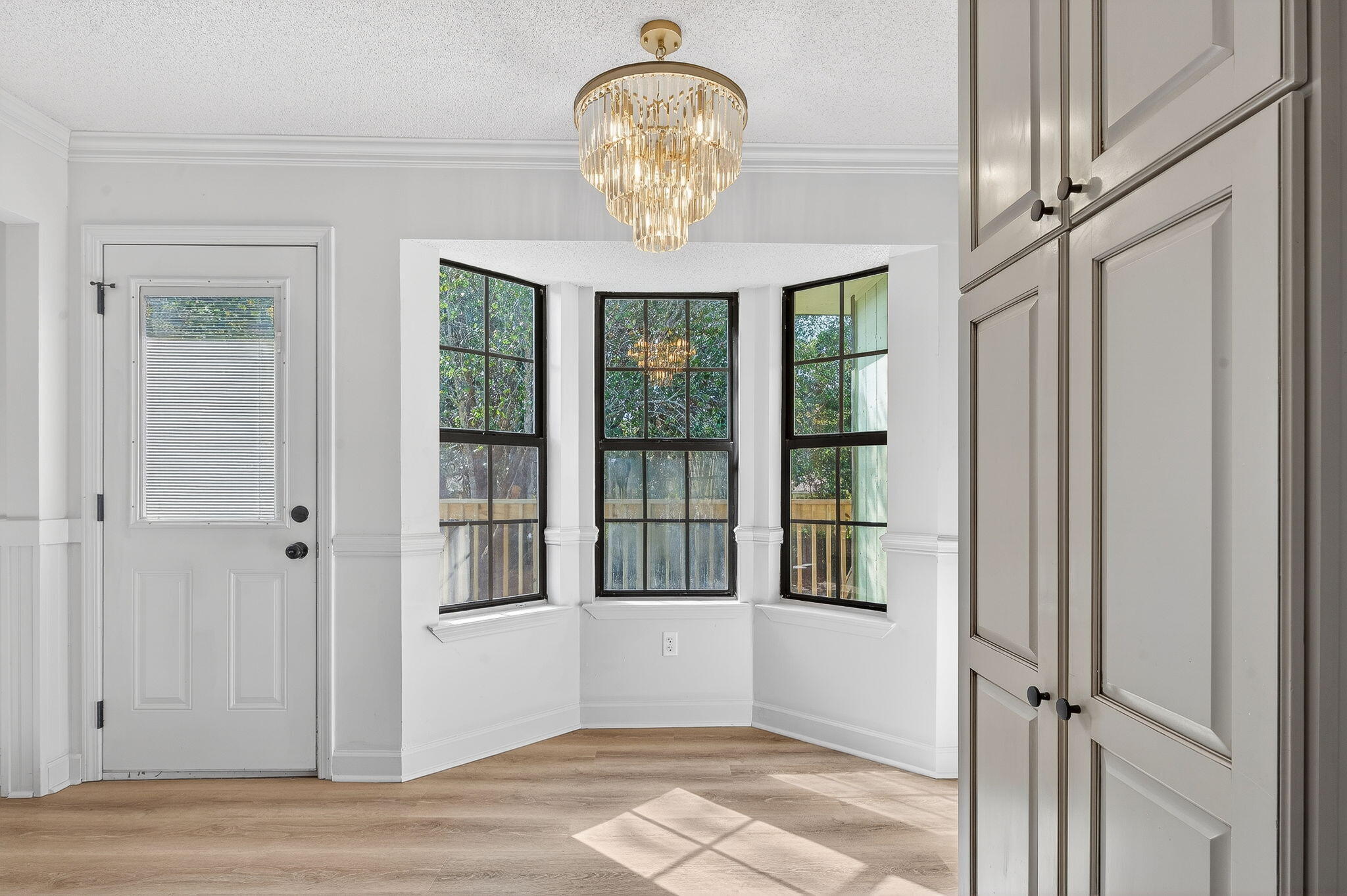 932 Ridgewood Way Niceville, FL 32578 - Photo 10 of 47 a view of a livingroom with a chandelier curtains and windows