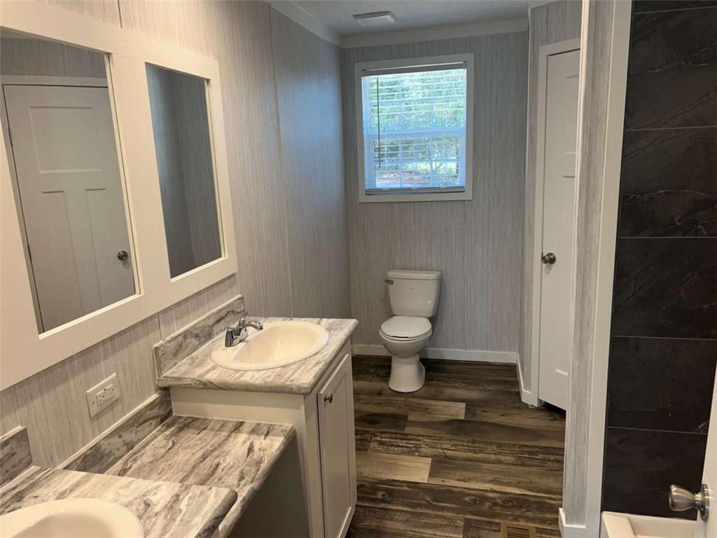 5041 Young Road Gainesville, GA 30506 - Photo 14 of 18 a bathroom with a sink toilet and shower