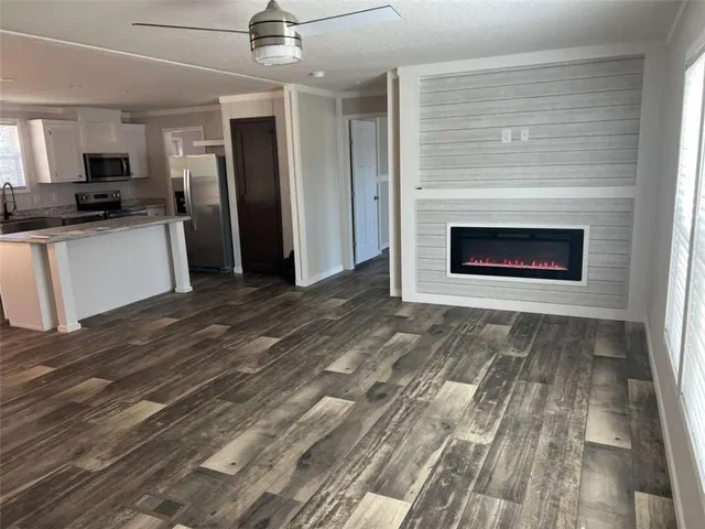 a view of kitchen with granite countertop cabinets and refrigerator