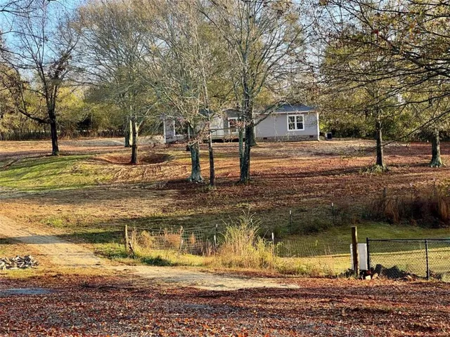 a view of a yard with large trees