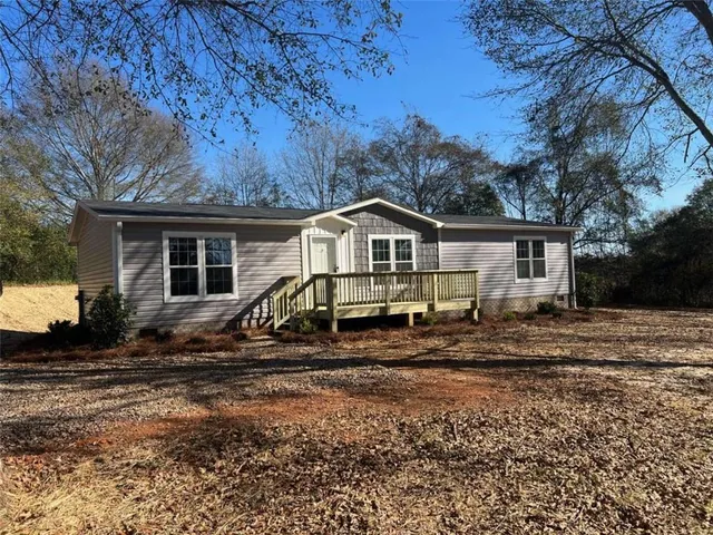a kitchen with a refrigerator sink and wooden floor