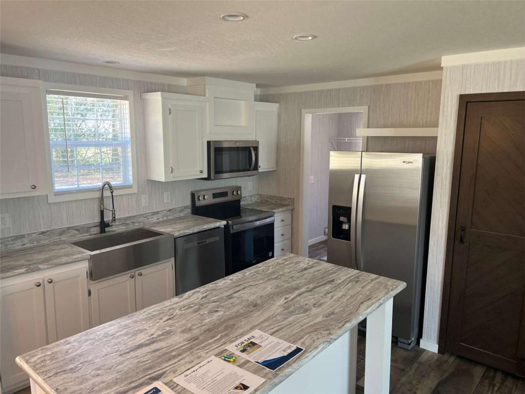 5041 Young Road Gainesville, GA 30506 - Photo 9 of 18 a kitchen with a refrigerator sink and wooden floor