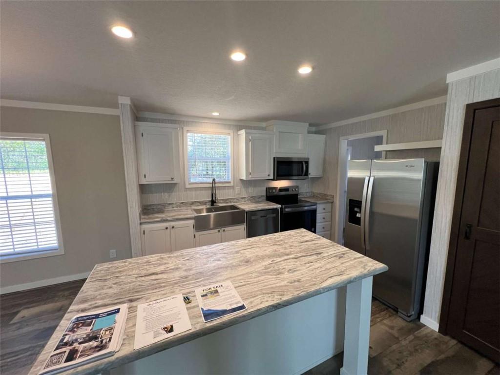 5041 Young Road Gainesville, GA 30506 - Photo 10 of 18 a kitchen with kitchen island a sink stainless steel appliances and window