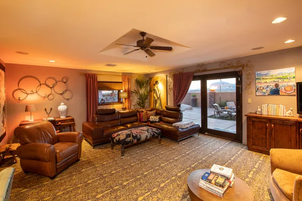 a living room with furniture and a floor to ceiling window