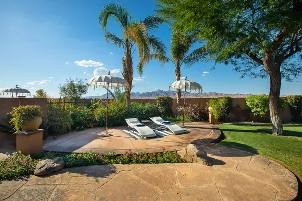 a view of a lush green outdoor space with a lake view