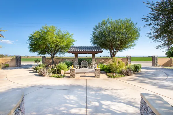 a kitchen with stainless steel appliances granite countertop a stove top oven a sink a dining table and chairs with wooden floor