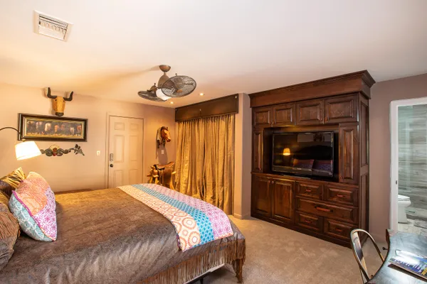 a bedroom with a bed and a chandelier