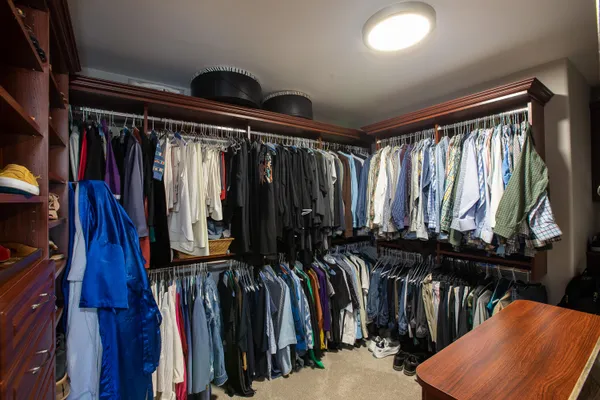 a bedroom with a bed couch tv and a window