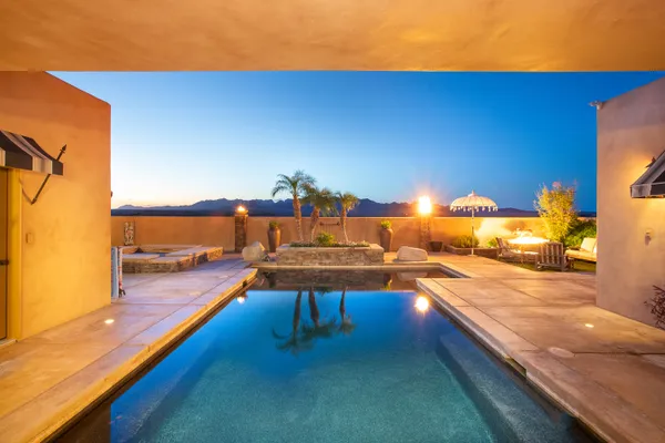 a view of a chairs and table in backyard