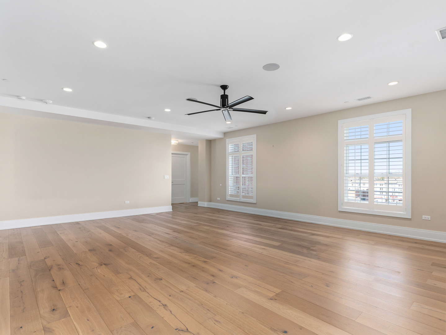 110 South Washington Street, Unit 400 Naperville, IL 60540 - Photo 11 of 54 a view of an empty room with wooden floor and a window