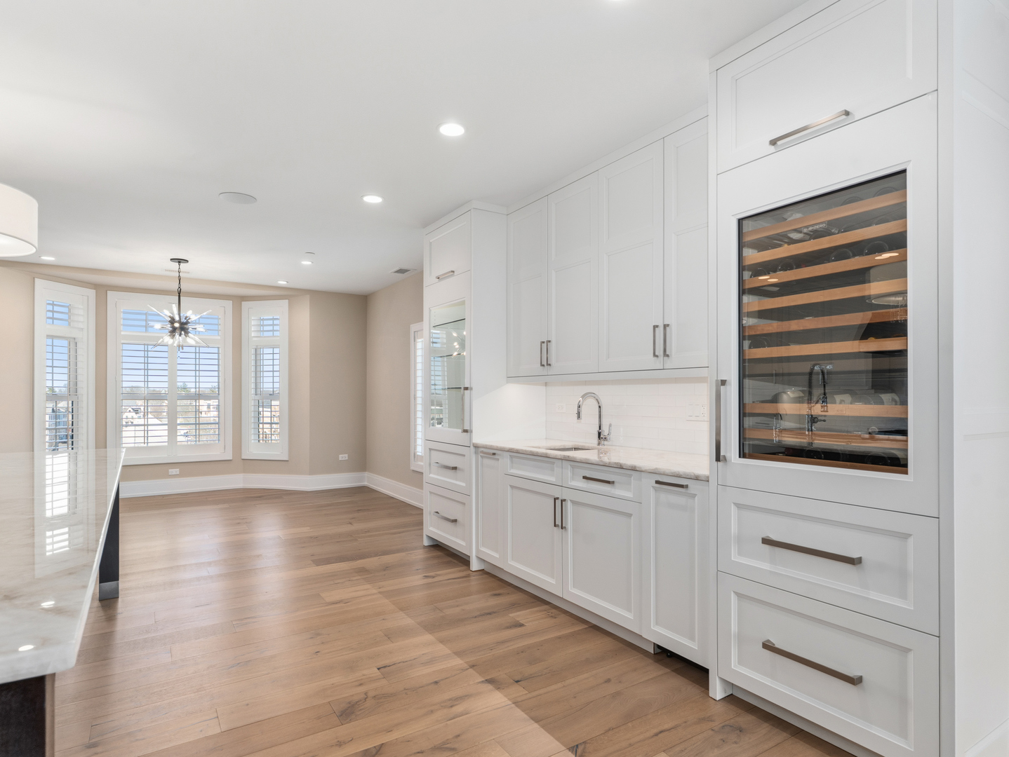 110 South Washington Street, Unit 400 Naperville, IL 60540 - Photo 20 of 54 a kitchen with white cabinets and sink