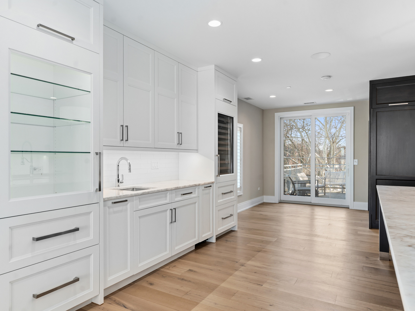 110 South Washington Street, Unit 400 Naperville, IL 60540 - Photo 21 of 54 a large white kitchen with granite countertop a large window and a white stove