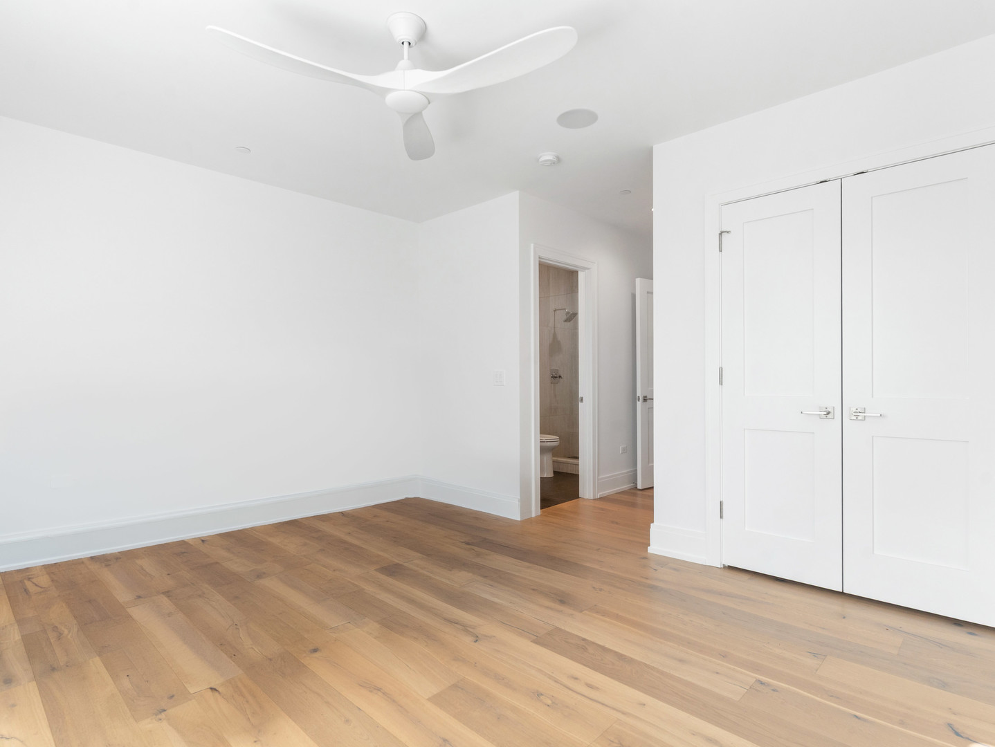 110 South Washington Street, Unit 400 Naperville, IL 60540 - Photo 36 of 54 an empty room with wooden floor and fan