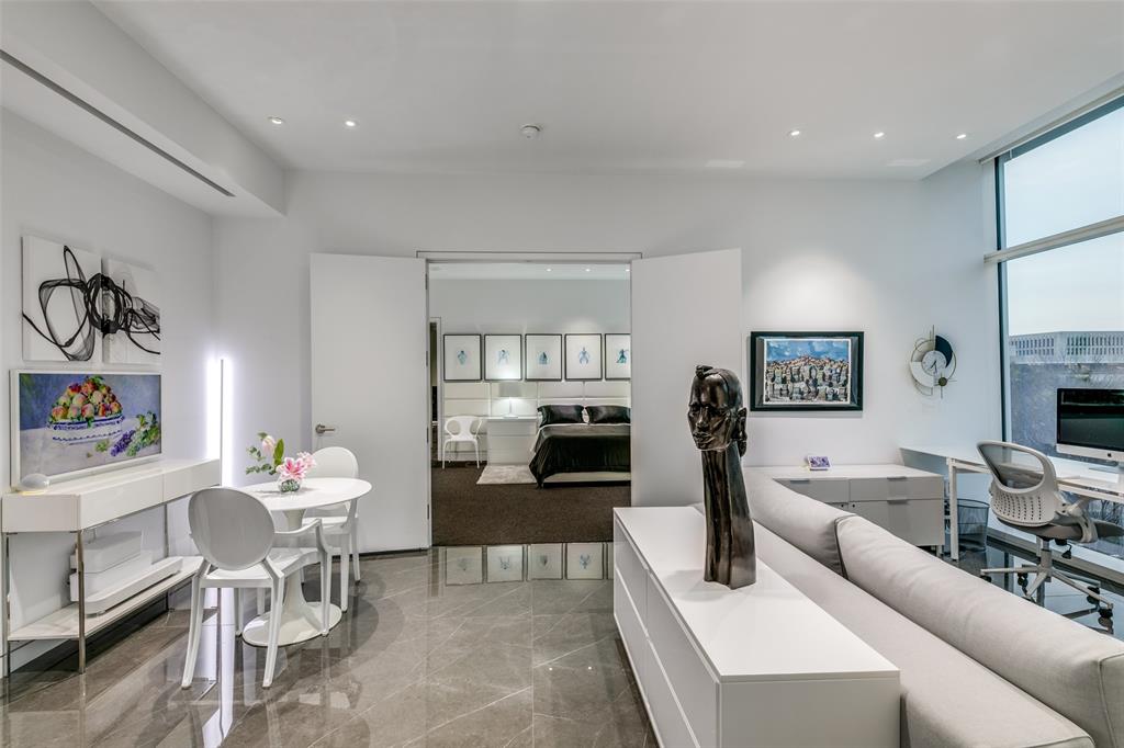 1918 Olive Street, Unit 202 Dallas, TX 75201 - Photo 13 of 36 a living room with furniture a fireplace and a flat screen tv