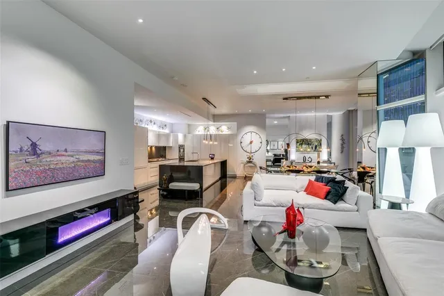 a living room with furniture and a chandelier