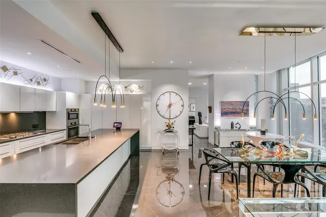 a large kitchen with a table and chairs