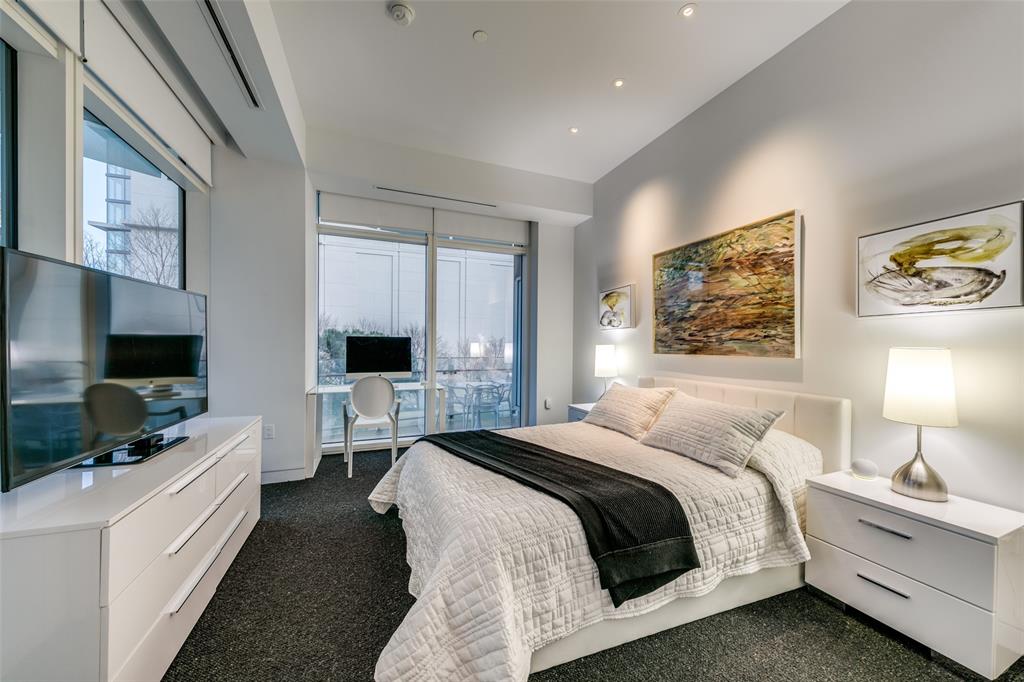 1918 Olive Street, Unit 202 Dallas, TX 75201 - Photo 21 of 36 a bedroom with a bed and a flat screen tv