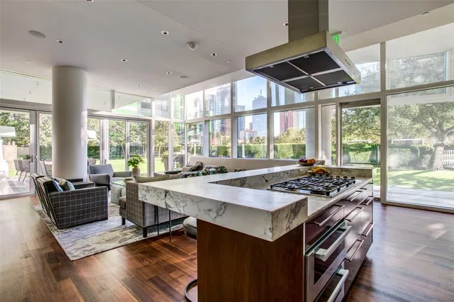 a kitchen with a stove a sink and wooden floor