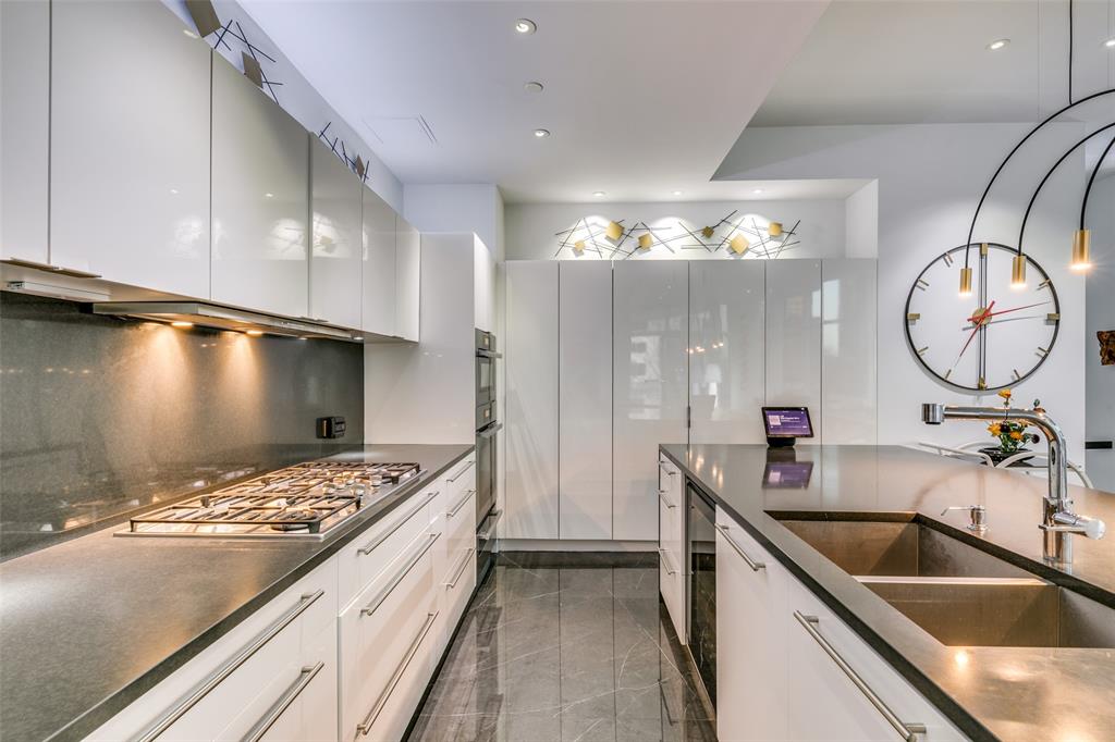 1918 Olive Street, Unit 202 Dallas, TX 75201 - Photo 9 of 36 a kitchen with a sink and a stove