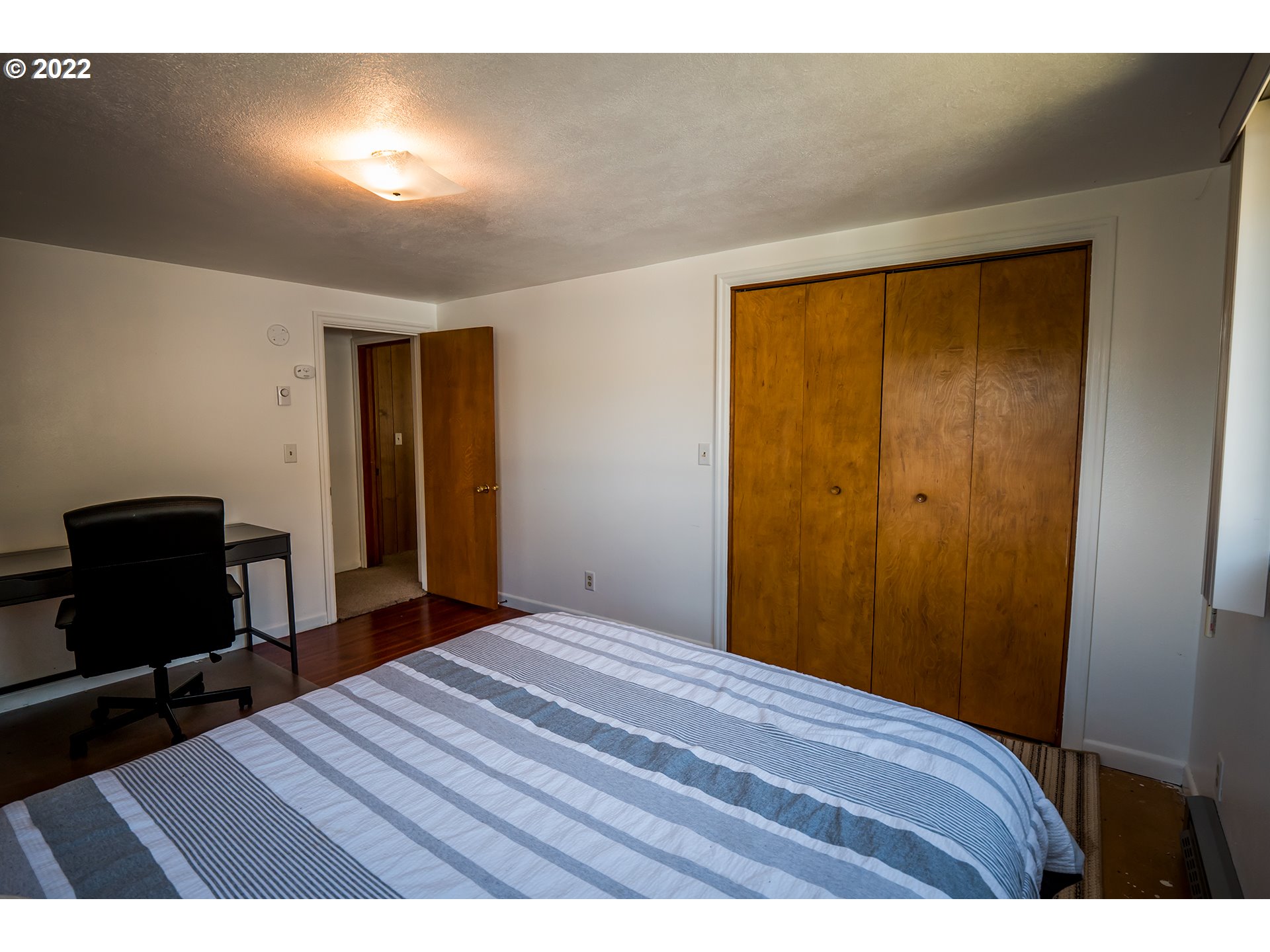 1648 Augusta Street Eugene, OR 97403 - Photo 11 of 29 a bedroom with a bed and a table in it