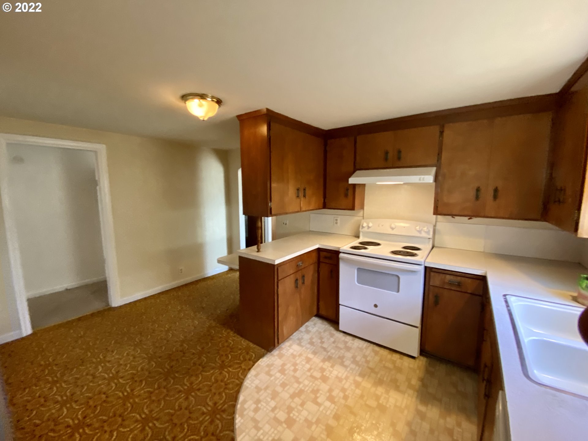 1648 Augusta Street Eugene, OR 97403 - Photo 7 of 29 a kitchen with granite countertop a sink stove and refrigerator