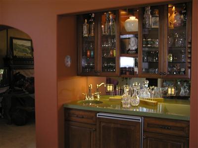 For the host and hostess...a well stocked and lit bar is essential for entertaining. This Sub Zero bar fridge and elegant dispay case for crystal as well as the storage below for the less attractive bar items will delight everyone you invite!