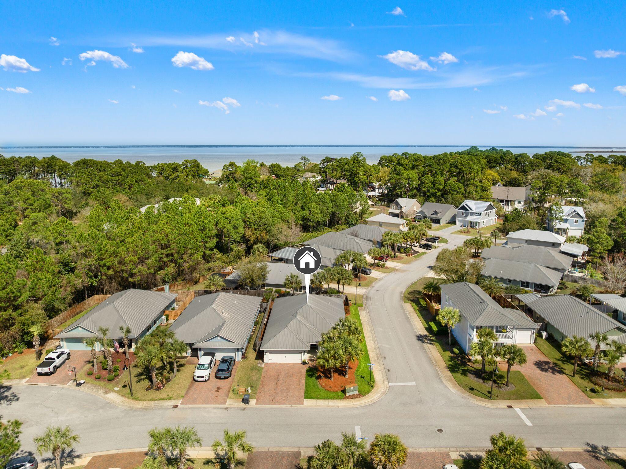 an aerial view of a houses with a yard