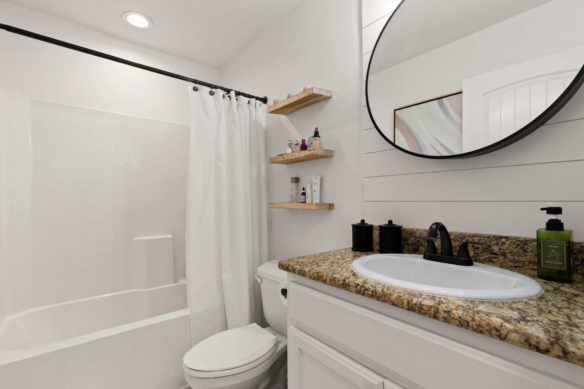 10 Golden Eagle Court Santa Rosa Beach, FL 32459 - Photo 24 of 36 a bathroom with a granite countertop sink toilet and a mirror