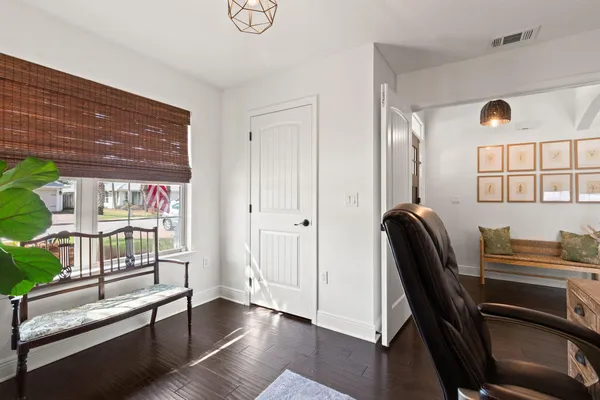 a view of a workspace with furniture and a window