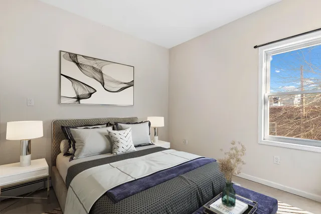 a bedroom with a bed and a window