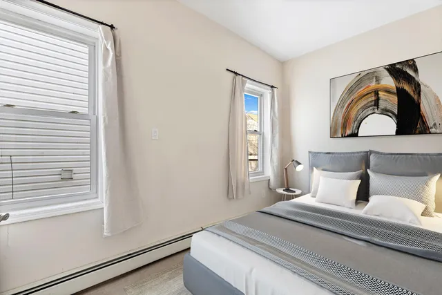 a bedroom with a bed and lamp