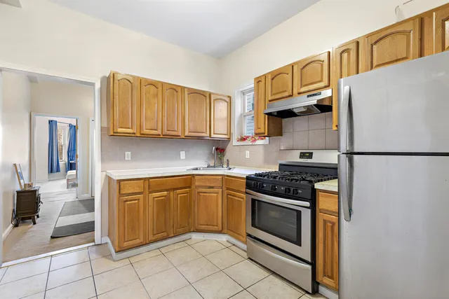 a kitchen with granite countertop a stove top oven microwave and cabinets