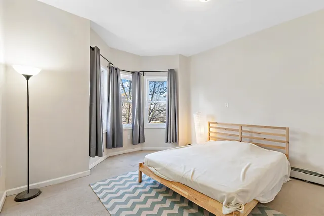 a bedroom with a bed and window