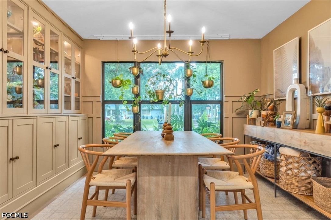 202 Ridgewood Avenue Clewiston, FL 33440 - Photo 11 of 50 a view of a dining room with furniture large windows and wooden floor
