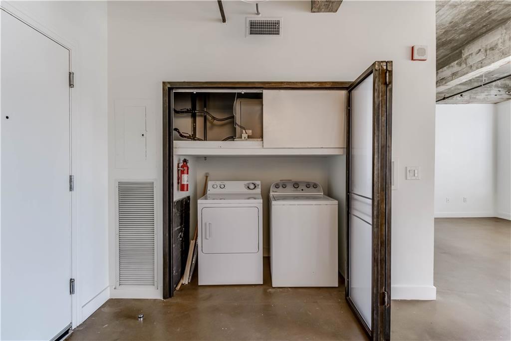 710 Colorado Street, Unit G9 Austin, TX 78701 - Photo 8 of 25 A dedicated laundry space, thoughtfully integrated for modern living.