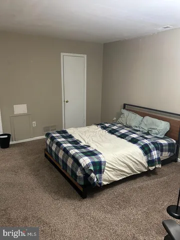 a bedroom with a bed and a lamp