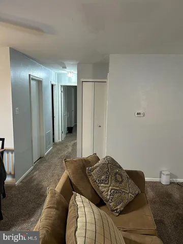 a living room with a bed and furniture