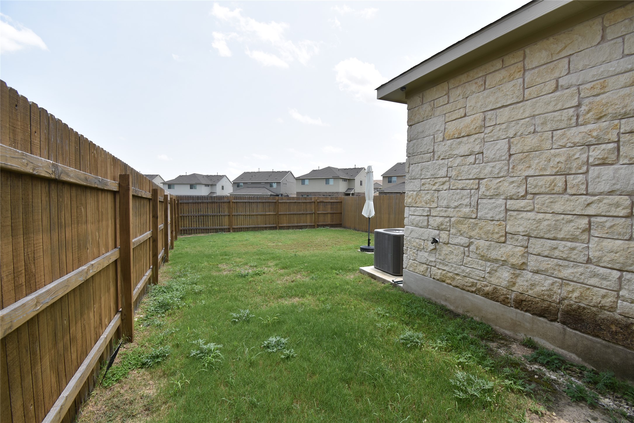 331 Alamar Knot Way, Unit 208 Georgetown, TX 78626 - Photo 16 of 17 A fully fenced yard offers a private outdoor retreat with space for recreation.