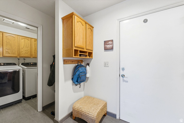 7930 Mustang Loop Road Park City, UT 84098 - Photo 18 of 23 Laundry area with separate washer and dryer, cabinet space, and light tile patterned floors