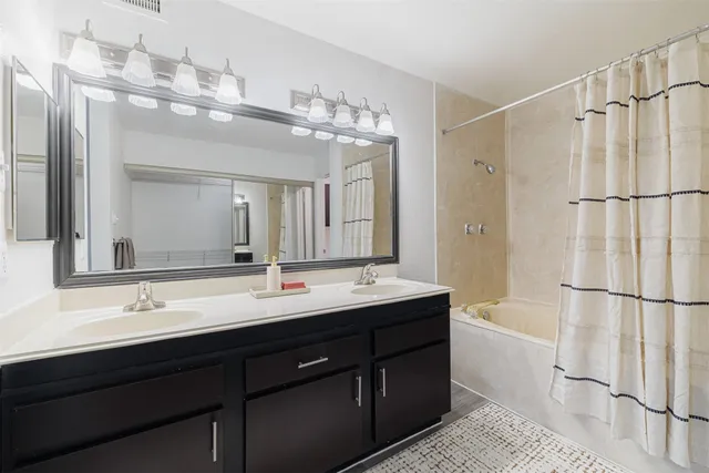 a bathroom with a double vanity sink mirror and double