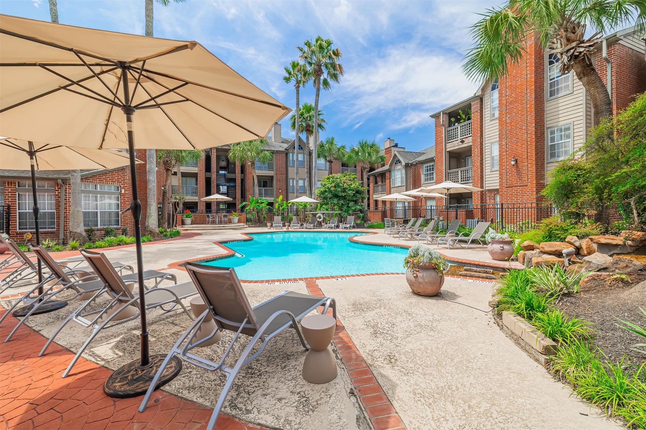 8300 El Mundo Street, Unit 192 Houston, TX 77054 - Photo 17 of 27 a view of a patio with couches and table and chairs under an umbrella