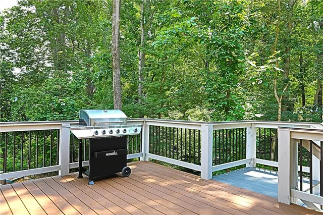 a view of a deck with wooden floor and fence