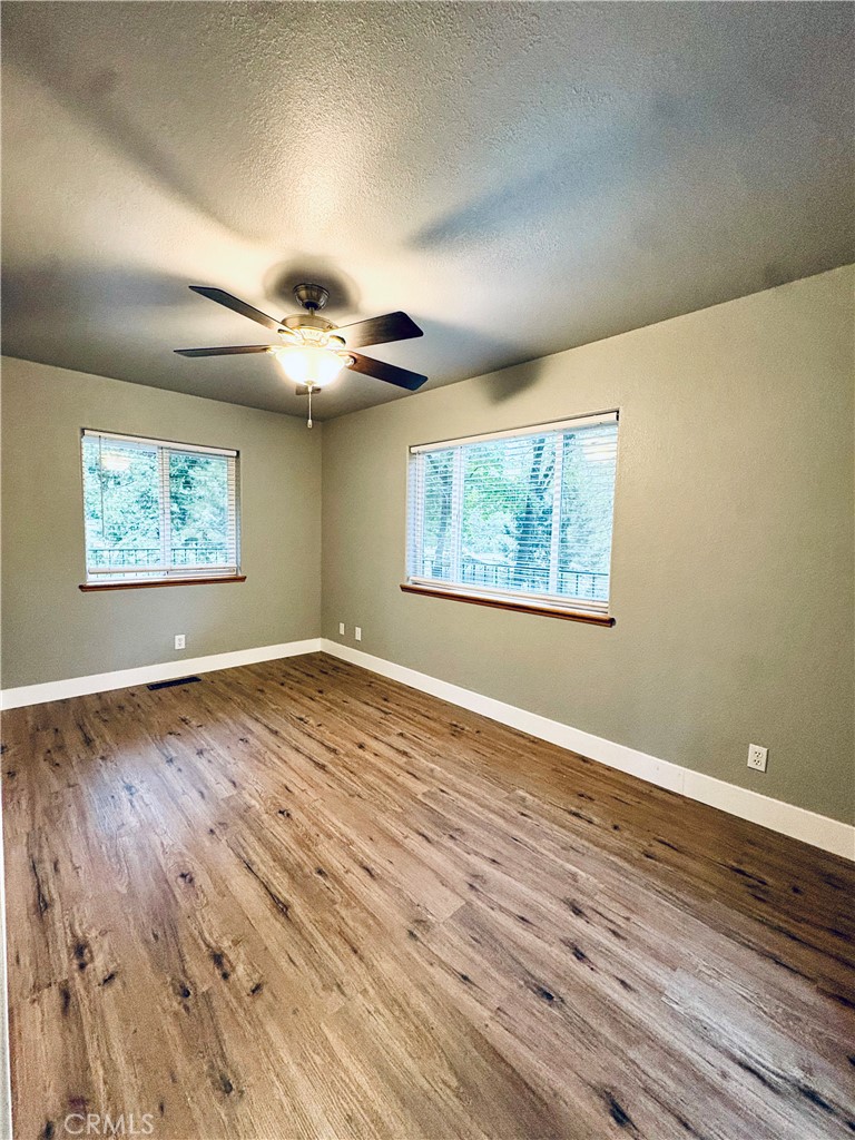 4728 Hartley Drive Forest Ranch, CA 95942 - Photo 12 of 33 a view of an empty room with wooden floor and a window
