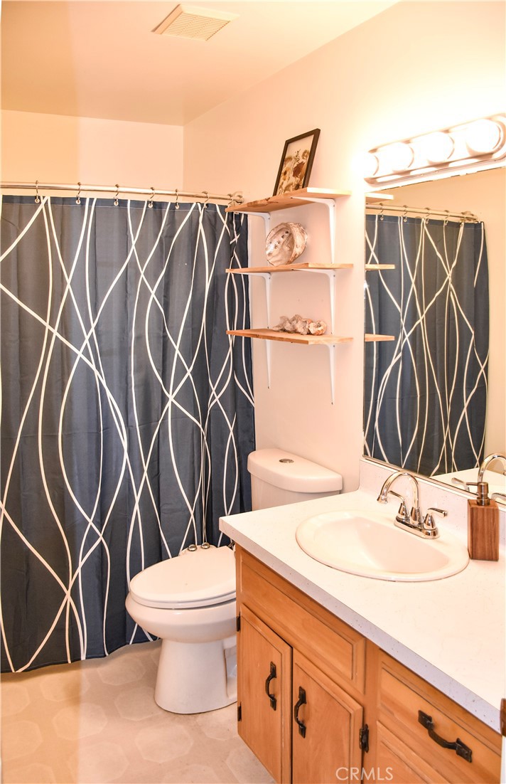 4728 Hartley Drive Forest Ranch, CA 95942 - Photo 15 of 33 a bathroom with a sink a mirror and a shower