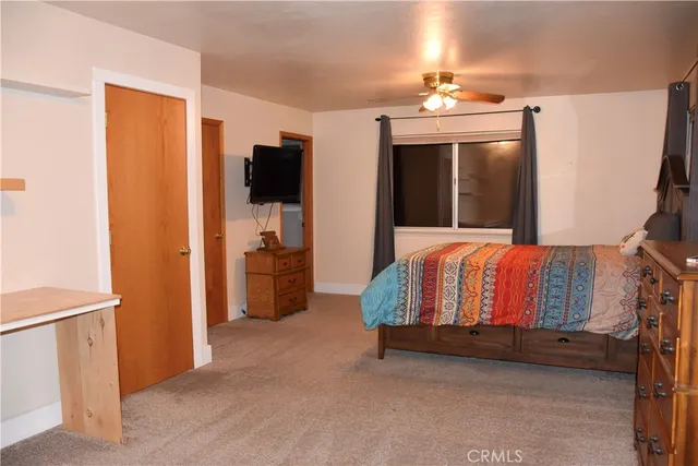 a bedroom with a bed and a television