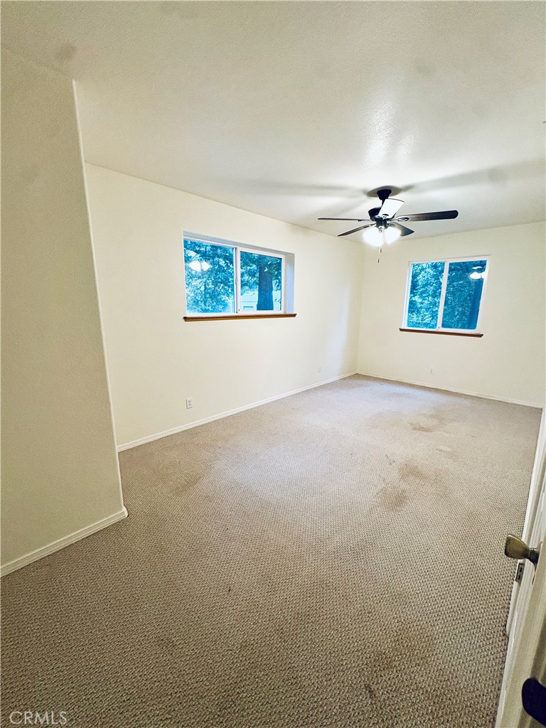 4728 Hartley Drive Forest Ranch, CA 95942 - Photo 25 of 33 an empty room with windows and fan