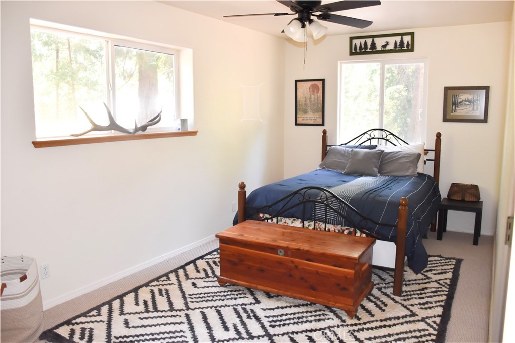 4728 Hartley Drive Forest Ranch, CA 95942 - Photo 26 of 33 a bedroom with a bed and wooden floor