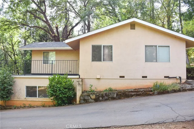 a house that has a tree in front of the house